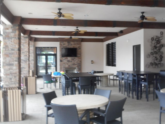 dining area with ceiling fan, beamed ceiling, and radiator