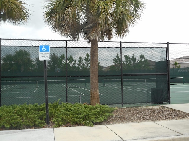 5265 Oakbourne Ave, Davenport, FL 33837 - view of tennis court with fence