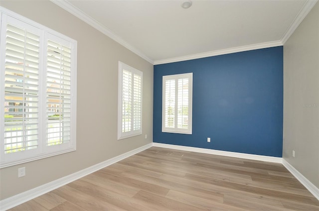 unfurnished room with ornamental molding and light hardwood / wood-style flooring