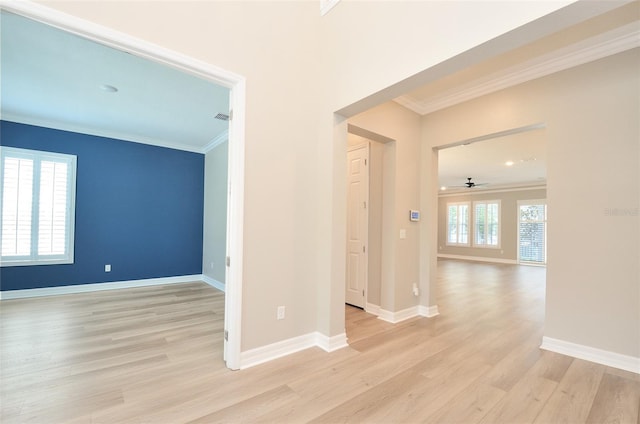 empty room with ceiling fan, light hardwood / wood-style floors, and ornamental molding