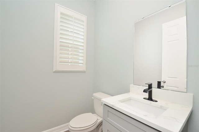 bathroom featuring toilet and vanity