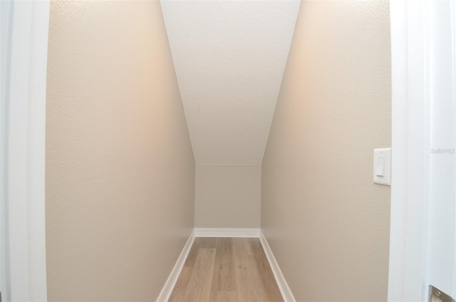 interior space featuring vaulted ceiling and light hardwood / wood-style flooring