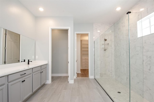 bathroom featuring tile patterned flooring, an enclosed shower, and vanity