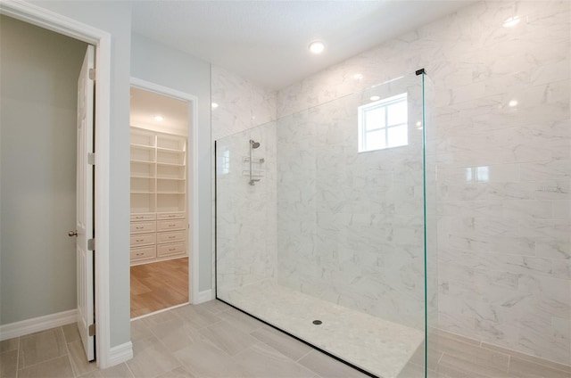 bathroom with tile patterned flooring and walk in shower