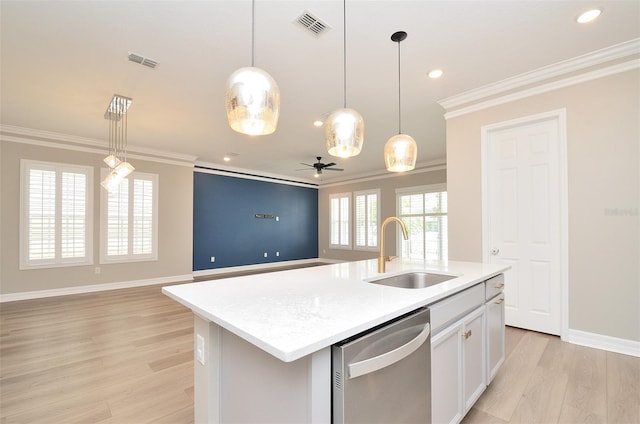 kitchen with dishwasher, decorative light fixtures, light hardwood / wood-style flooring, sink, and an island with sink