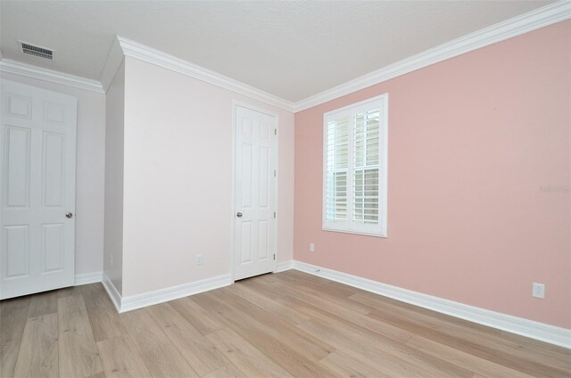 unfurnished bedroom with light hardwood / wood-style floors and crown molding