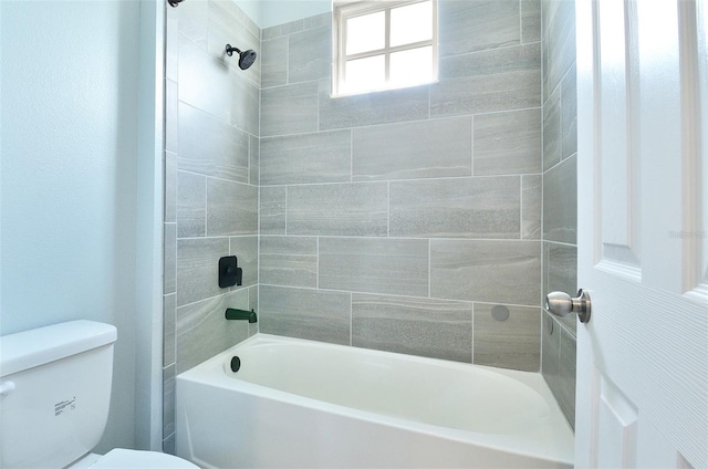 bathroom featuring toilet and tiled shower / bath combo