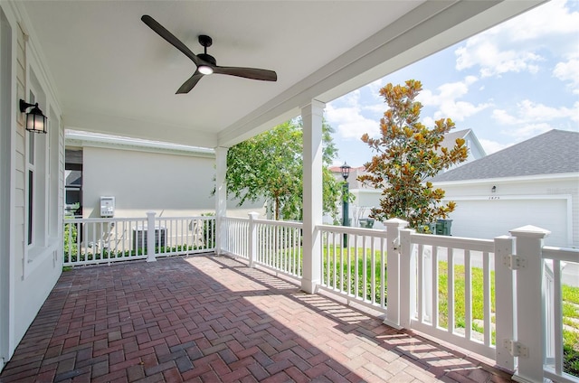 view of patio featuring ceiling fan and a garage