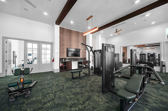 exercise room with ceiling fan, carpet floors, a high ceiling, and french doors