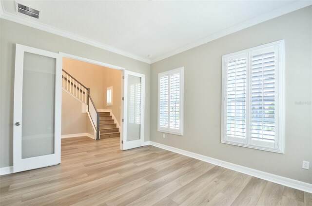 1862 Beach Ridge Rd, Celebration, FL 34747 - unfurnished room featuring light wood-style flooring, stairway, ornamental molding, baseboards, and french doors