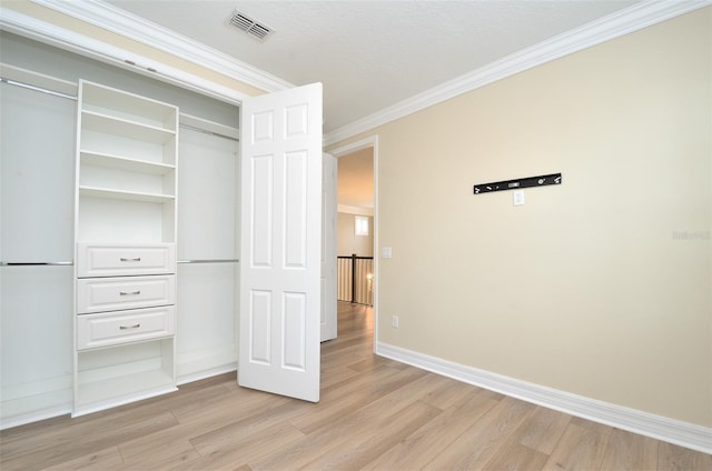 1862 Beach Ridge Rd, Celebration, FL 34747 - unfurnished bedroom with light wood finished floors, crown molding, baseboards, and a closet