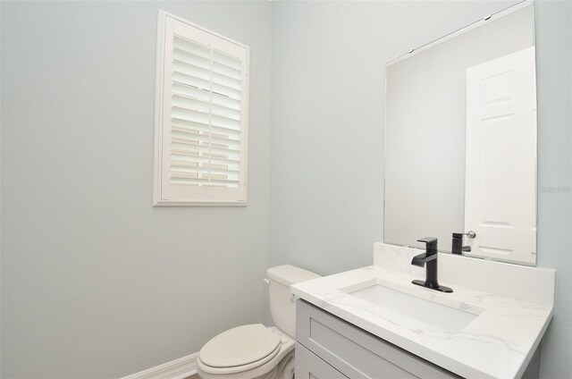 1862 Beach Ridge Rd, Celebration, FL 34747 - half bathroom featuring toilet, vanity, and baseboards