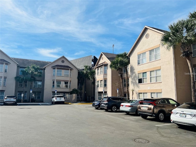 view of building exterior featuring uncovered parking