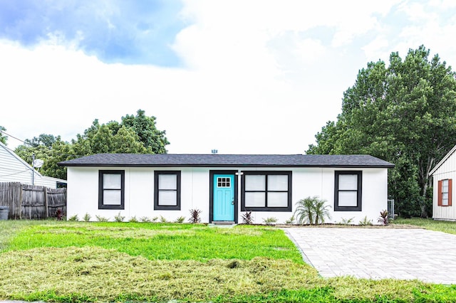 ranch-style home with a front lawn