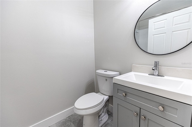 bathroom with vanity, toilet, and tile patterned floors