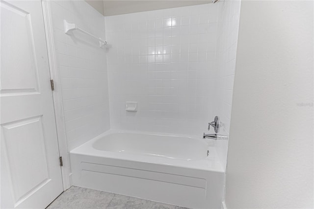 bathroom with tile patterned flooring and tiled shower / bath