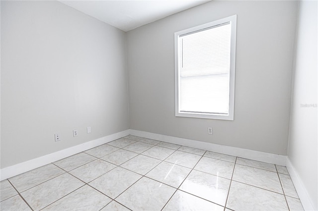 unfurnished room featuring light tile patterned flooring