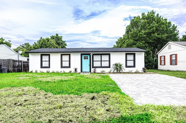 1411 Overdale St, Orlando, FL 32825 - view of front of property featuring a front yard, stucco siding, fence, and a shingled roof