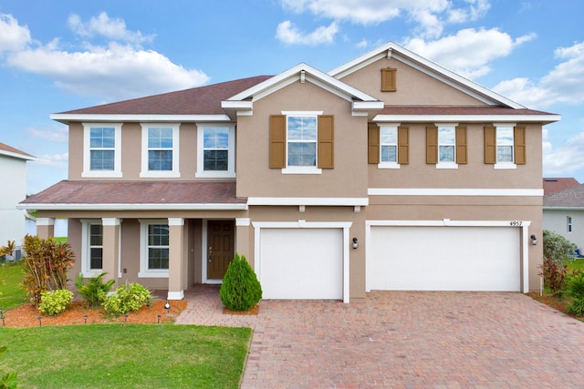 view of front facade featuring a front lawn and a garage