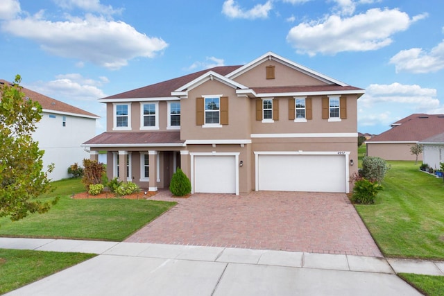 view of front of house with a garage and a front lawn