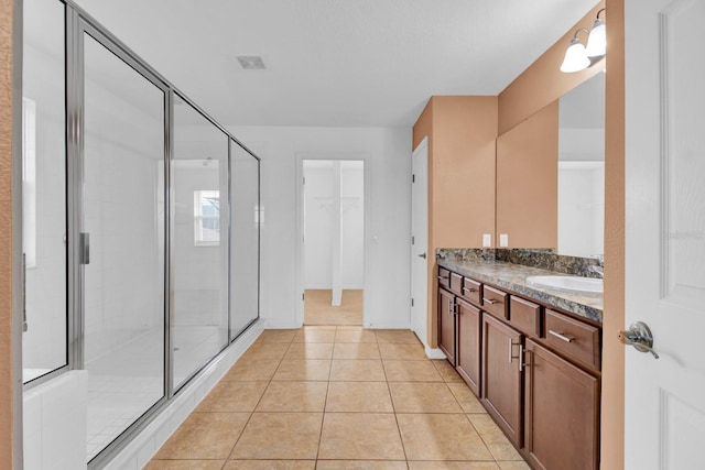 bathroom with vanity, tile patterned floors, and an enclosed shower