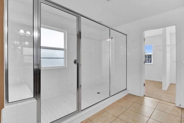 bathroom with tile patterned floors and walk in shower