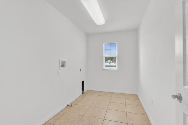 laundry room with gas dryer hookup, hookup for an electric dryer, washer hookup, and light tile patterned floors