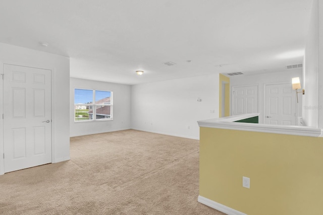 spare room with light colored carpet