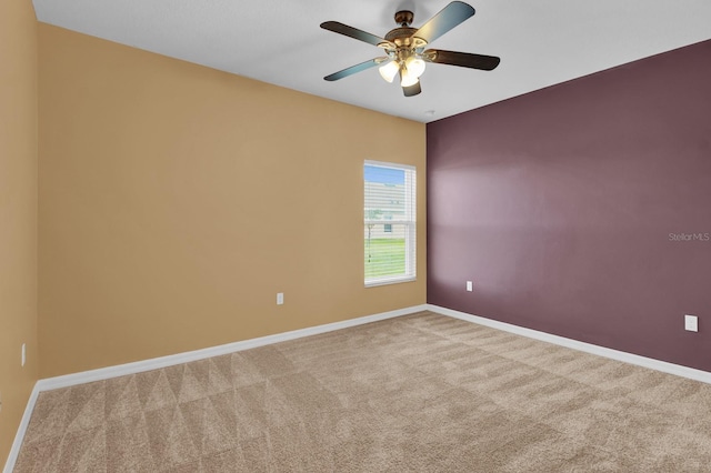 carpeted empty room featuring ceiling fan