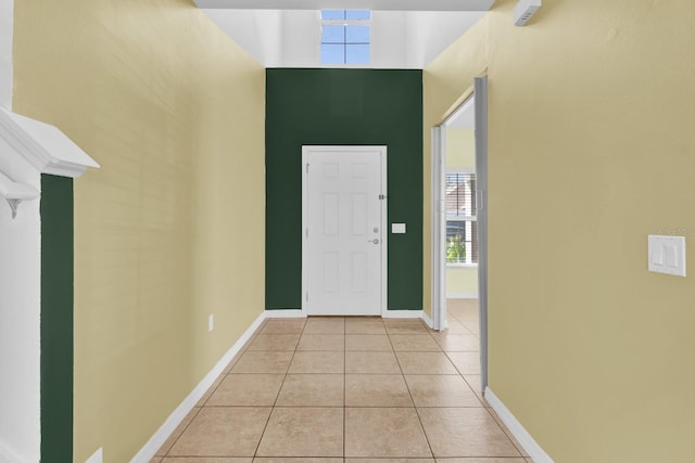 tiled entrance foyer with a high ceiling