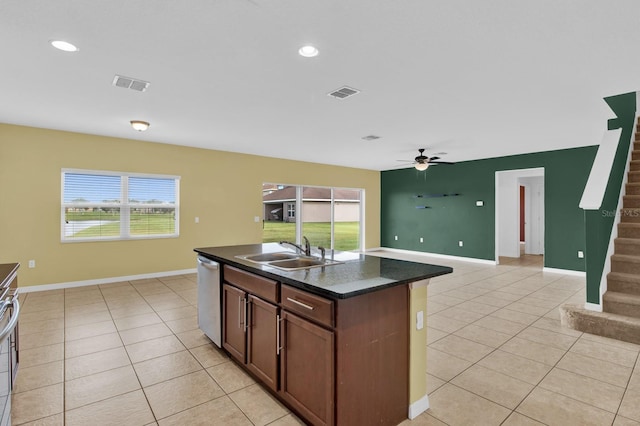 kitchen with dishwasher, a kitchen island with sink, sink, light tile patterned flooring, and ceiling fan