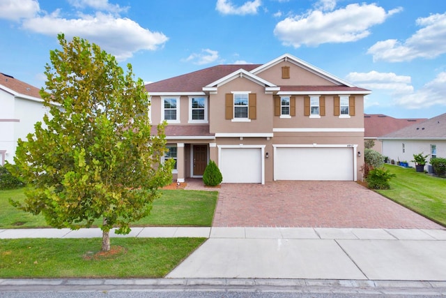 view of front of home featuring a front yard and a garage