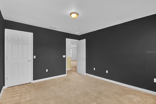 unfurnished bedroom with light colored carpet