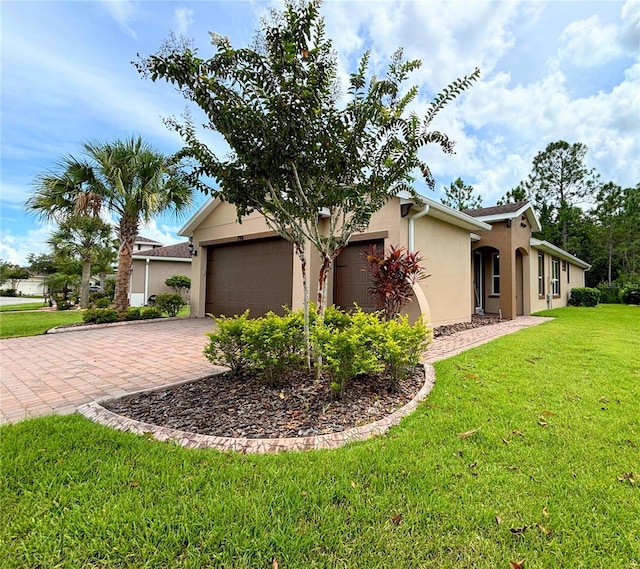 view of front of property with a front lawn and a garage