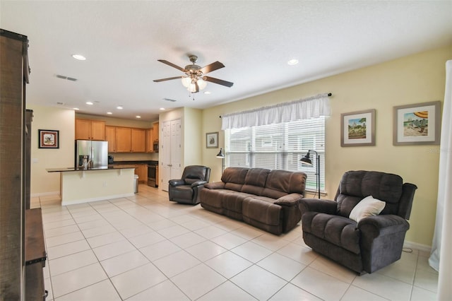 tiled living room with ceiling fan