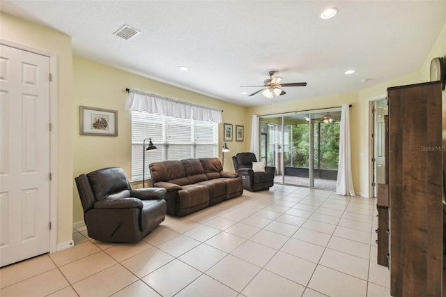 living room with ceiling fan and light tile patterned floors