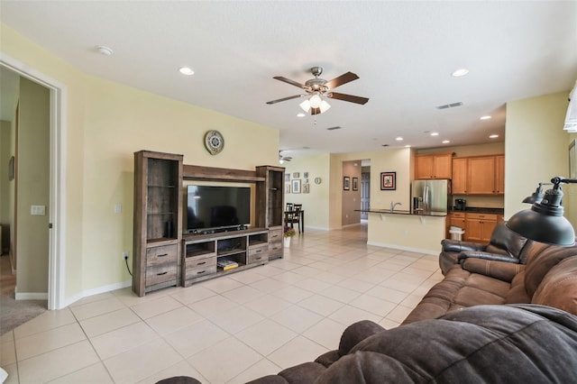 tiled living room with ceiling fan