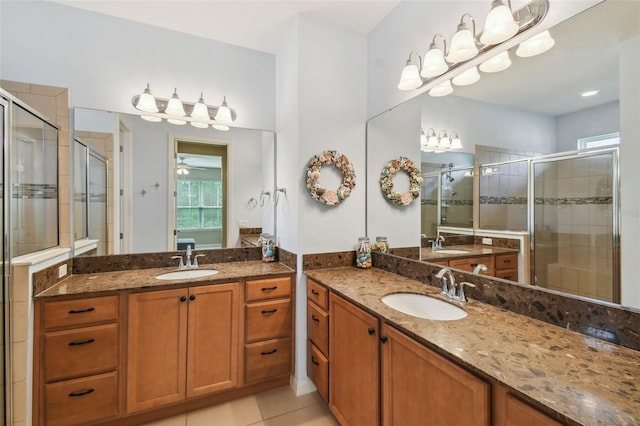 bathroom featuring tile patterned floors, an enclosed shower, and vanity