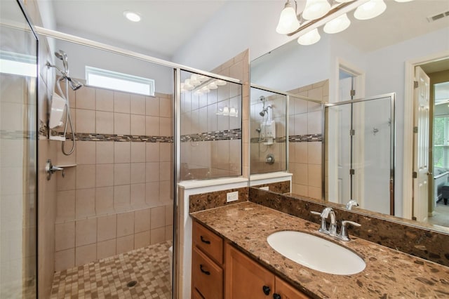 bathroom with a shower with door and vanity