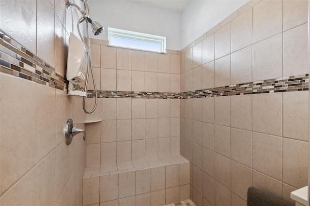 bathroom with a tile shower