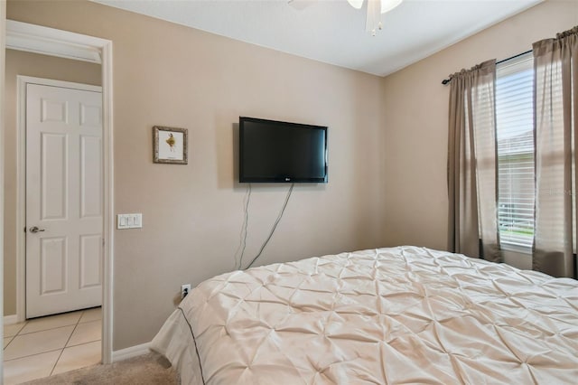 tiled bedroom with ceiling fan