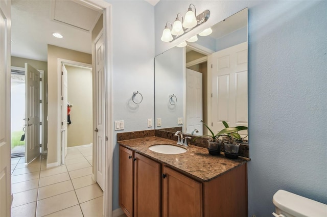 bathroom featuring tile patterned flooring, vanity, and toilet