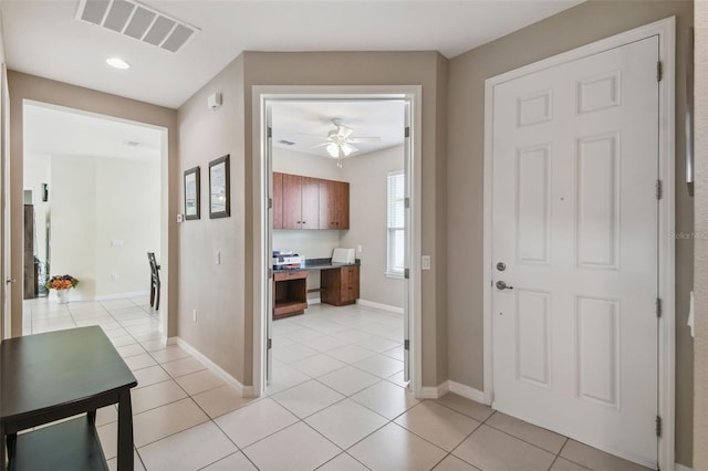 hall featuring light tile patterned floors