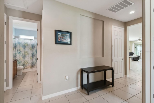 hallway with light tile patterned floors