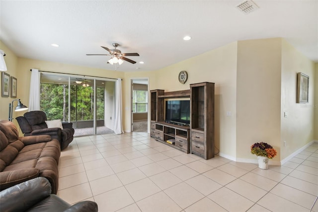 tiled living room with ceiling fan