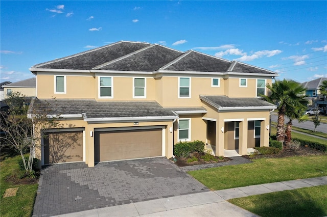 view of front of property with a front yard and a garage