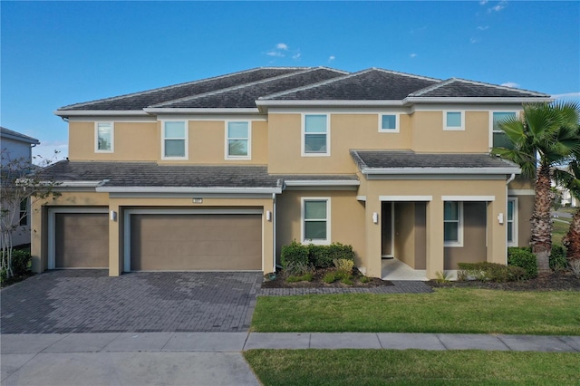 view of front of property featuring a front yard and a garage