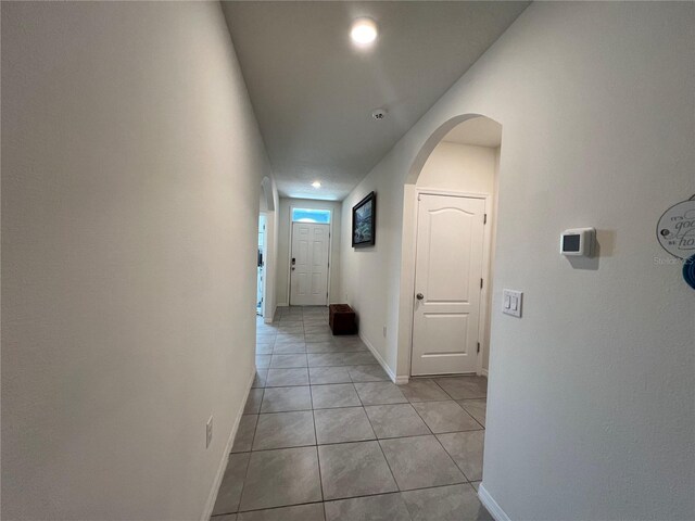 corridor with light tile patterned floors