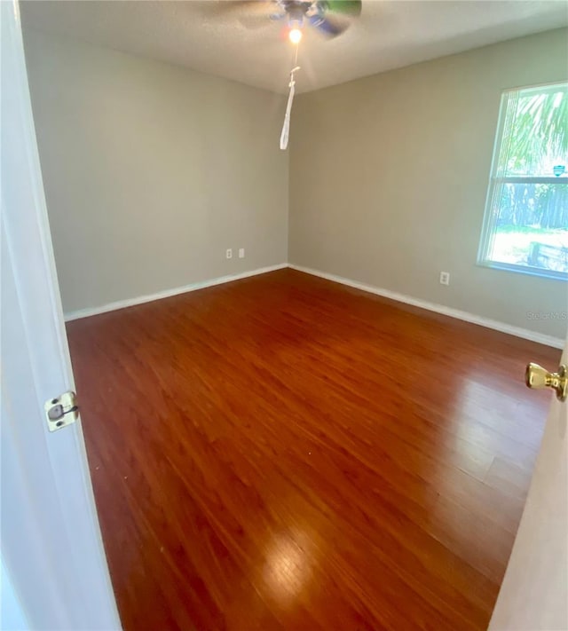 unfurnished room with ceiling fan and hardwood / wood-style floors