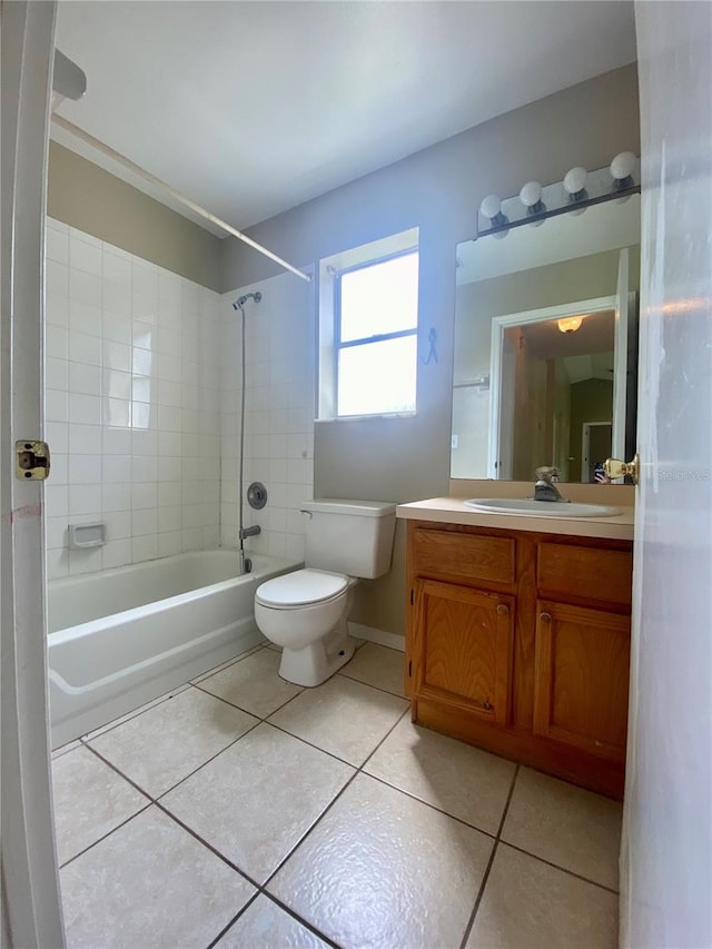 full bathroom featuring tile patterned flooring, toilet, vanity, and tiled shower / bath